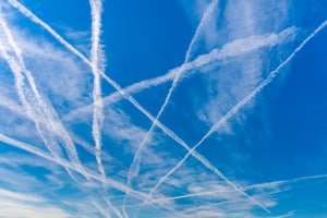 Contrails over blue sky.